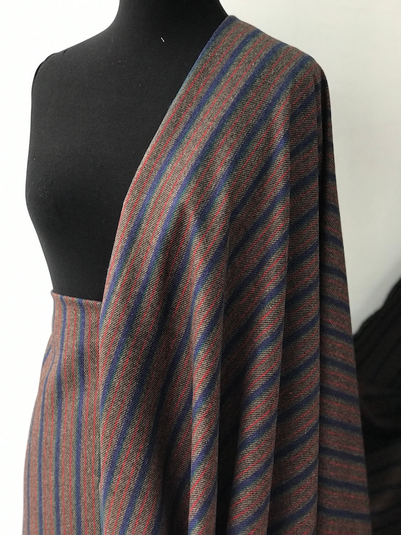 May include: Striped fabric in brown, blue, and red. The fabric has a diagonal stripe pattern.
