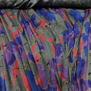 Geometric print knitted jersey fabric magenta pink teal blue colours for dressmaking location Onas