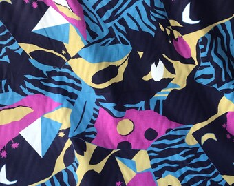 May include: Abstract fabric with a blue, yellow, pink, and white geometric pattern. The fabric has a textured surface and is perfect for crafting projects.