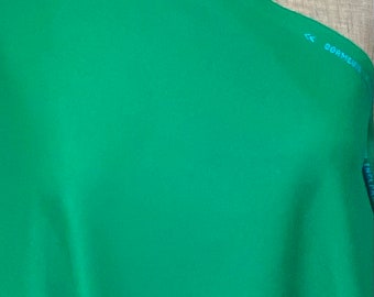 May include: A bright green fabric swatch with the text "MADE IN ENGLAND" and "DORMEUIL" printed on it.