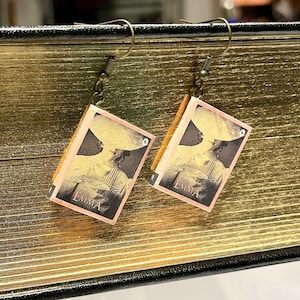 May include: A pair of handmade earrings in the shape of miniature books. Each earring showcases a vintage image of a woman in a hat, with the title "Emma" and the author's name. The earrings have bronze-coloured ear wires.