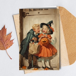 May include: A vintage Halloween card showing two children in costume. A boy in a cape and a girl in an orange dress and witch hat. The girl holds a carved pumpkin. The card is on a white surface with a dried leaf and a brown envelope.