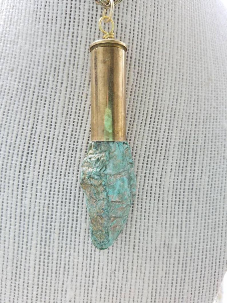Fushcite mica gemstone in .45 brass bullet casing pendant with a gold plated necklace