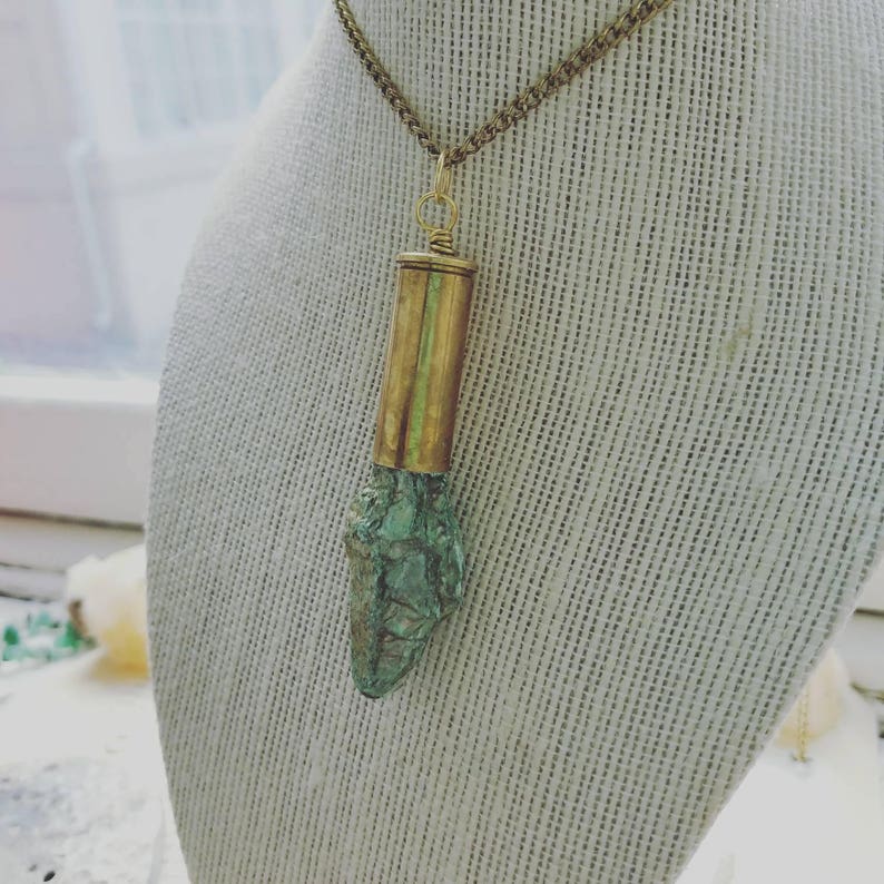 Fushcite mica gemstone in .45 brass bullet casing pendant with a gold plated necklace