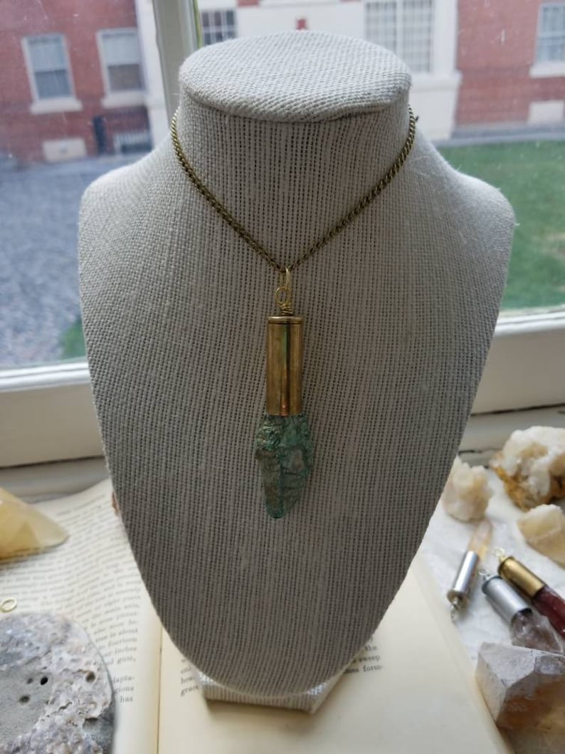 Fushcite mica gemstone in .45 brass bullet casing pendant with a gold plated necklace