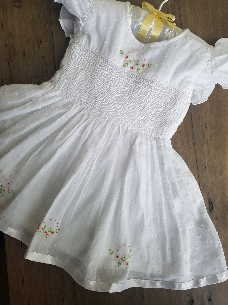 Beautiful spot white hand smocked and embroidered baby dress