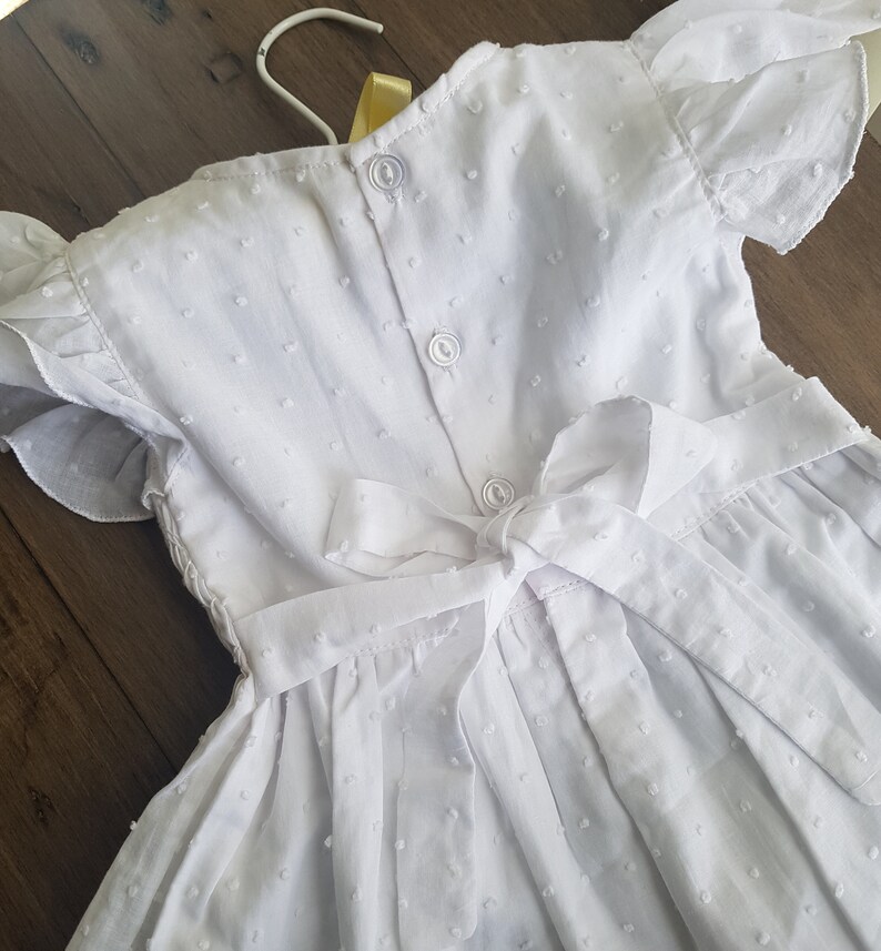 Beautiful spot white hand smocked and embroidered baby dress
