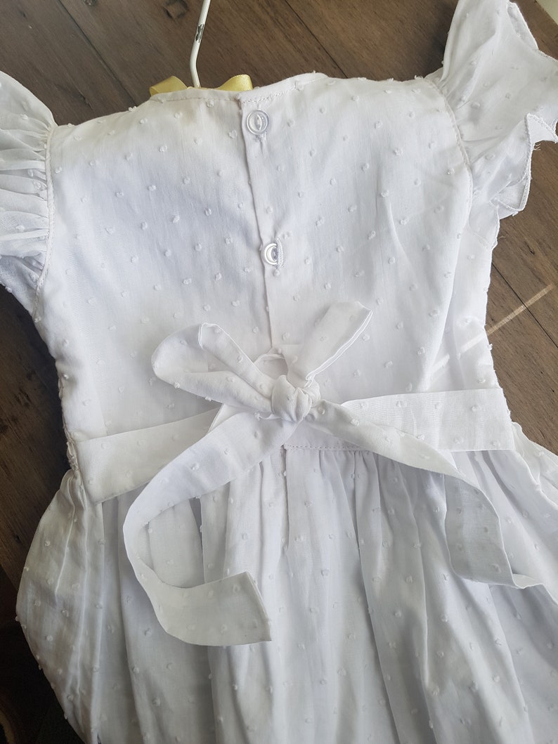 Beautiful spot white hand smocked and embroidered baby dress