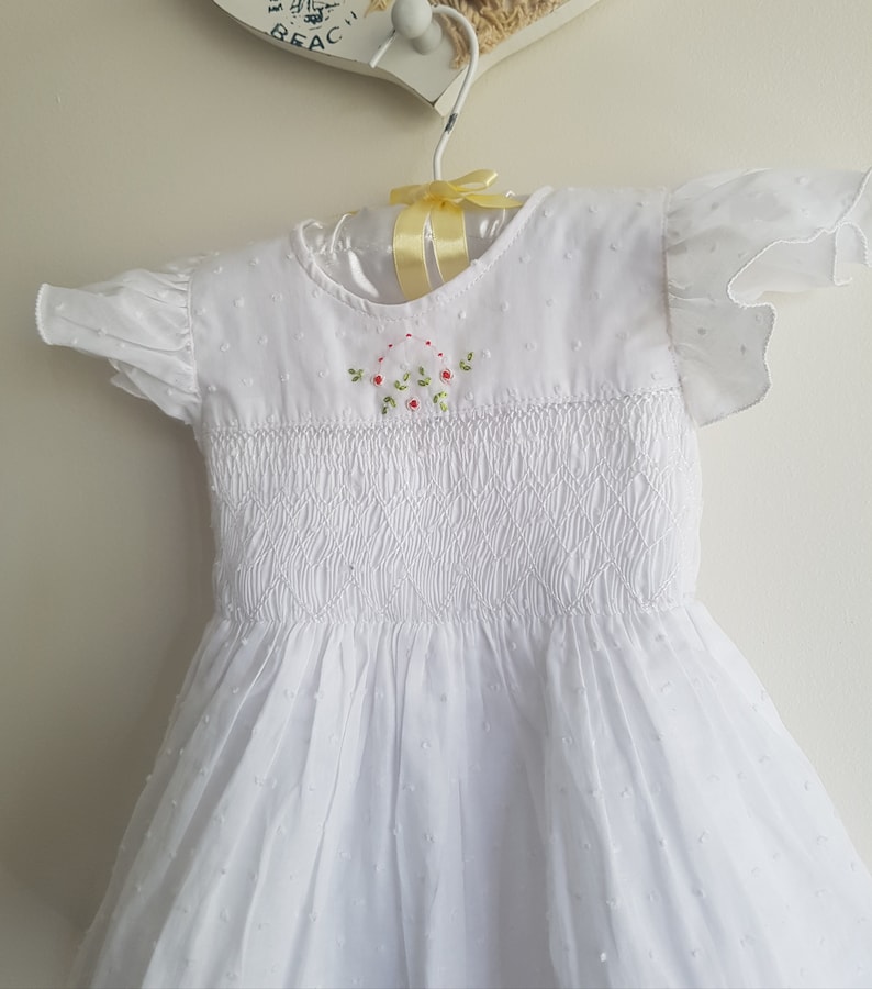 Beautiful spot white hand smocked and embroidered baby dress