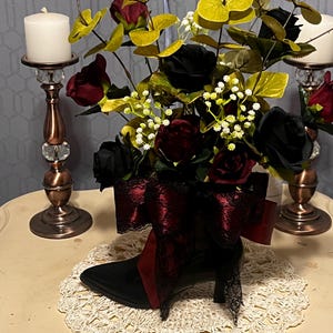 black cowboy boot flower arrangement with bow