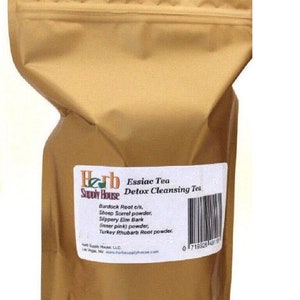 May include: A gold foil pouch with a label that reads "Herb Supply House Essiac Tea Detox Cleansing Tea". The label lists the ingredients: Burdock Root c/s, Sheep Sorrel powder, Slippery Elm Bark (inner pink) powder, Turkey Rhubarb Root powder.