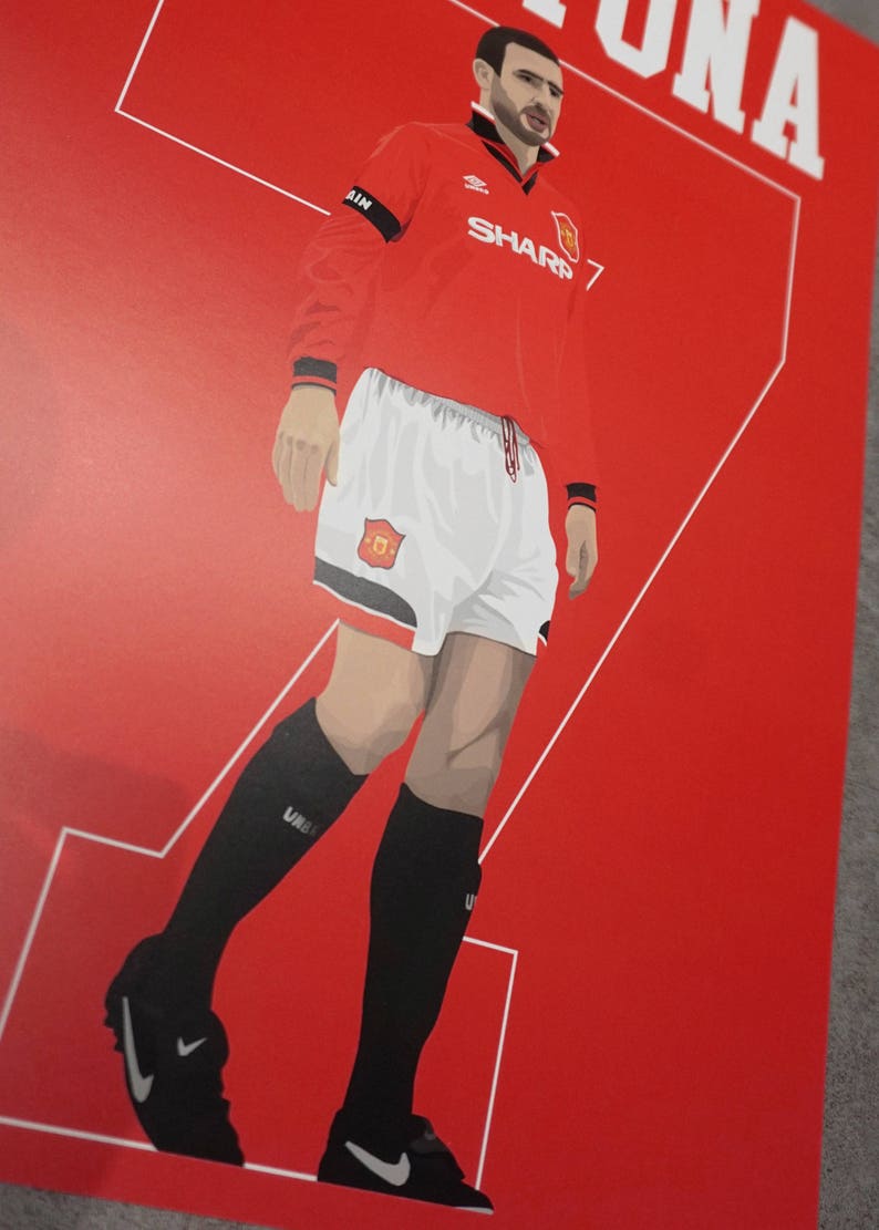 May include: Illustration of a soccer player in a red jersey with white shorts and black socks. The jersey has the word "SHARP" and the number "7" on it. The background is red with white lines and the name "CANTONA".