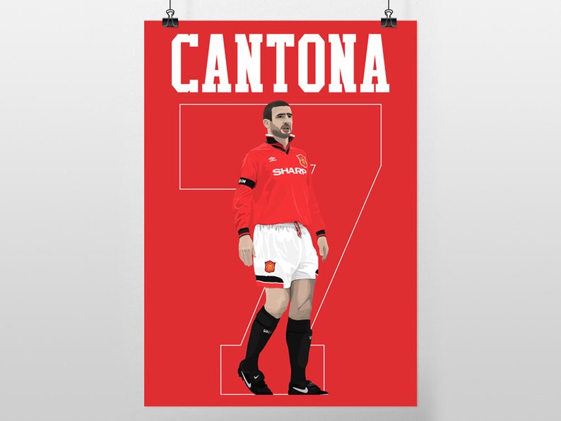 May include: A red poster featuring a stylized illustration of a soccer player in a red jersey with the name "CANTONA" above. The player is wearing a jersey with the number 7, white shorts, and black socks and shoes.