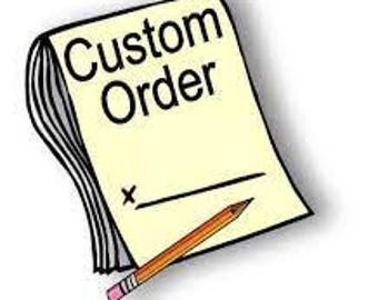 May include: A yellow notepad with the words "Custom Order" written in black. A pencil is lying on top of the notepad.