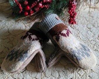 May include: A pair of knitted mittens with a brown, gray, and white pattern. The mittens have a gray cuff and a brown trim.