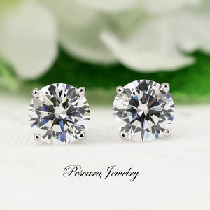 May include: A pair of silver stud earrings with clear round cubic zirconia stones.