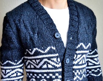 May include: A dark blue knitted cardigan with a white geometric pattern. The cardigan has a v-neck and a button closure.