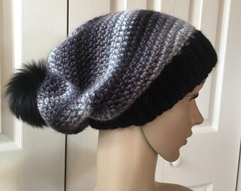 Slouchy self stripping Hat with Faux Fur Pom-Pom!  Blend of gray/blue/black tones. Ribbed band. Very trendy.