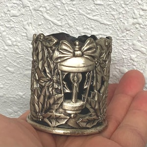 cast metal candle holder, maybe pewter candle holder, intricate candle holder, candle holder, candle, intricate candle holder, engravings