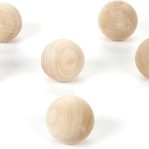 May include: A set of three ceramic mugs with a speckled, matte finish. The mugs are in shades of cream, light gray, and dark gray. Each mug has a simple, minimalist design and a rounded handle.