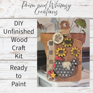 May include: DIY unfinished wood craft kit, ready to paint. The kit includes a wooden cutting board shape with a chicken, sunflowers, and a tag that says "Fresh Eggs". The board has a handle and is decorated with a red heart and yellow star.
