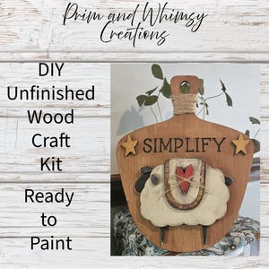 May include: A DIY unfinished wood craft kit ready to paint. The wooden piece is shaped like a cutting board with a sheep design. The word "SIMPLIFY" is above the sheep, and the text "Prim and Whimsy Creations" is at the top.
