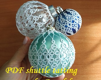 May include: Three white crocheted Christmas ornaments, one on a clear glass ball, one on a blue glass ball, and one on a teal glass ball. The ornaments are made with a shuttle tatting pattern. The text "PDF shuttle tatting pattern by Renulek" is at the bottom of the image.