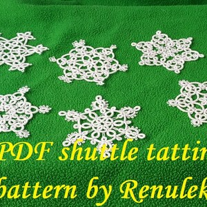 May include: Six white snowflake-shaped crocheted doilies on a green background. The text "PDF shuttle tatting pattern by Renulek" is below the doilies.