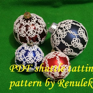 May include: Four white crocheted Christmas baubles on different coloured glass balls. The baubles are made with a shuttle tatting pattern. The text "PDF shuttle tatting pattern by Renulek" is at the bottom of the image.