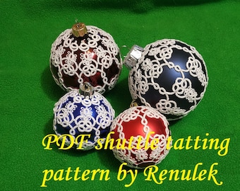 May include: Four white crocheted Christmas ornaments on different colored glass balls. The ornaments are made with a shuttle tatting pattern. The text "PDF shuttle tatting pattern by Renulek" is at the bottom of the image.