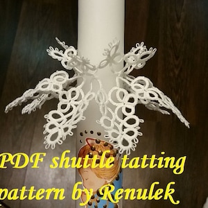 May include: White lace tatting pattern in the shape of a butterfly, with the text "PDF shuttle tatting pattern by Renulek" below.