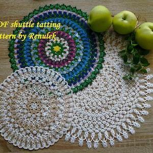 May include: Three white crocheted doilies with a colorful crocheted doily in the center. The text "PDF shuttle tatting pattern by Renulek" is visible in the image.