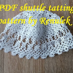 May include: White crocheted doily with a scalloped edge. The doily is made using the shuttle tatting technique. The image includes the text "PDF shuttle tatting pattern by Renulek."
