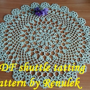 May include: A delicate, light blue crochet doily with a floral design. The doily is made with a shuttle tatting technique and is a PDF pattern by Renulek.