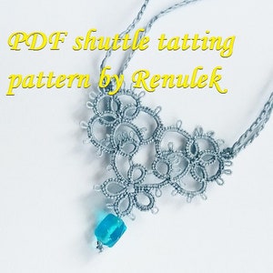 May include: A delicate gray shuttle tatted necklace with a turquoise bead pendant. The necklace is made with a fine thread and has a delicate, intricate design. The pendant is a small, square bead with a smooth, polished surface. The necklace is a beautiful example of shuttle tatting, a traditional craft that involves creating intricate patterns with thread and a shuttle.