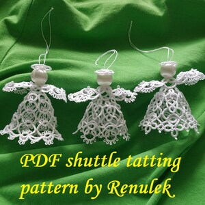 May include: Three white crocheted angel ornaments with pearl beads hanging from white string on a green background. The text "PDF shuttle tatting pattern by Renulek" is below the ornaments.