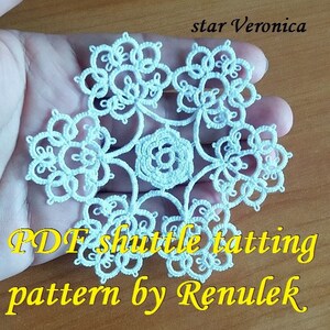 May include: White crocheted snowflake pattern, called "star Veronica", with the text "PDF shuttle tatting pattern by Renulek".