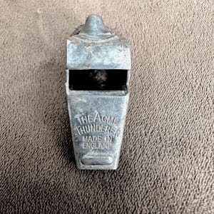 May include: A silver whistle with the words "The Acme Thunderer Made in England" engraved on the side.