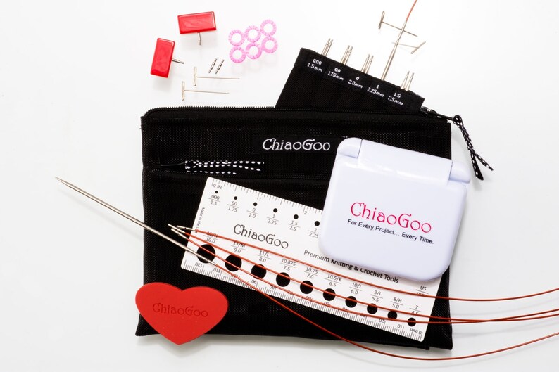 May include: A set of knitting needles and tools in a black zippered pouch. The set includes a variety of sizes of needles, a ruler, a gauge tool, and a heart-shaped stitch marker. The pouch is labeled "ChiaoGoo" and the tools are labeled "ChiaoGoo For Every Project. Every Time."