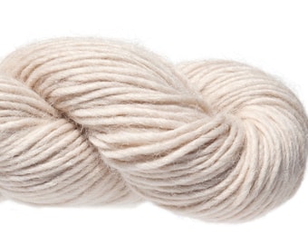 May include: A skein of soft, natural-colored yarn. The yarn is made of wool and is perfect for knitting or crocheting.