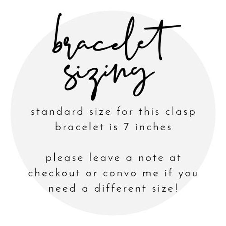 May include: A white circular graphic with the words "bracelet sizing" in black script. The text states the standard size for the clasp bracelet is 7 inches. Additional text requests a note at checkout for different sizes.
