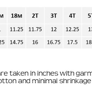 May include: A white chart with black text detailing chest width and length measurements in inches for children's clothing sizes 6 months to 10 years. The text at the bottom states measurements are taken in inches and the garment is 100% cotton.