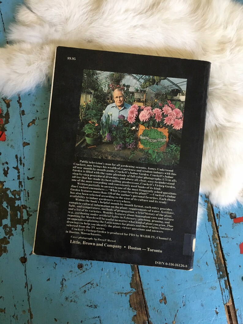 Puede incluir: La contraportada de un libro titulado "Crockett's Indoor Garden" de James Underwood Crockett. La portada presenta una foto de un hombre en un invernadero con una variedad de plantas. La portada del libro incluye el t&iacute;tulo, el autor, el editor y el n&uacute;mero ISBN.