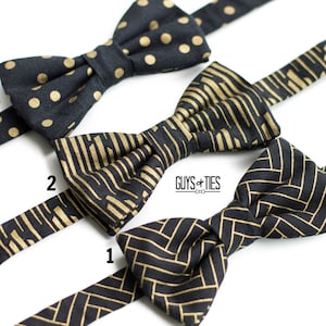 May include: Three black bow ties with gold patterns. The bow ties are arranged in a row, with the top bow tie featuring gold polka dots, the middle bow tie featuring gold stripes, and the bottom bow tie featuring a gold herringbone pattern. The bow ties are all made of fabric and have a satin finish.