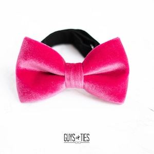 May include: A pink velvet bow tie with a black elastic band.