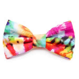 May include: A colorful bow tie with a tie-dye pattern in shades of pink, red, yellow, blue, and green.
