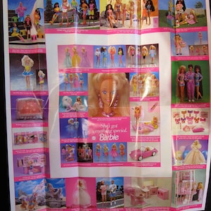 May include: A colorful poster featuring various Barbie dolls and playsets. The poster has a pink background with the text "She's got something special. Barbie" in the center. The poster features a variety of dolls, including Barbie, Ken, and Skipper, as well as playsets such as a house, a car, and a horse.