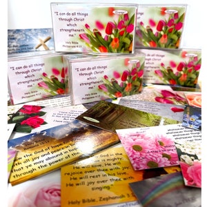 May include: A collection of inspirational quote cards with floral designs. The cards feature various bible verses, including "I can do all things through Christ which strengtheneth me." and "Now the God of hope fill you with all joy and peace in believing, that ye may abound in hope, through the power of the Holy Ghost."