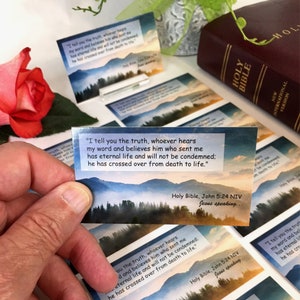 May include: A set of inspirational cards with a watercolor background featuring a quote from the Bible, "I tell you the truth, whoever hears my word and believes him who sent me has eternal life and will not be condemned; he has crossed over from death to life."  The cards are printed with the Bible verse, John 5:24 NIV, and the words "Jesus speaking..."