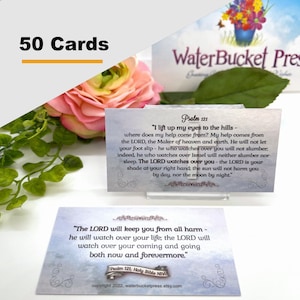 May include: A set of 50 cards with inspirational bible verses from Psalm 121. The cards feature a light blue background with a white border and a decorative floral design. The text on the cards is in black and white. The cards are perfect for encouraging and uplifting others.